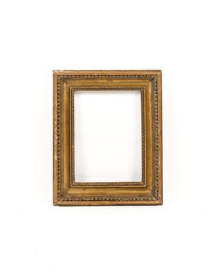 a gold picture frame on a white wall with a white background