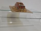 a small boat that is sitting on top of a glass shelf