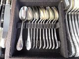 a lot of silver spoons and spoons in a case