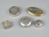 several silver objects are sitting on a white surface
