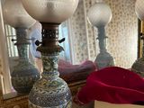 three lamps that are sitting on a table in front of a mirror