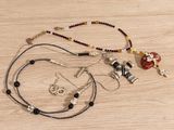 a necklace and earring set on a wooden table