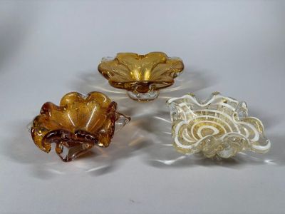 three pieces of glass sitting on top of each other on a table