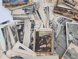 a pile of old postcards sitting on a table