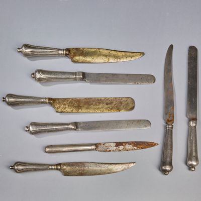seven knives and a knife on a table