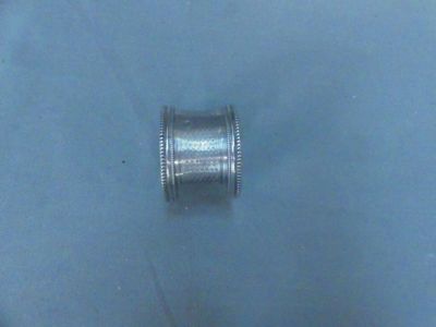 a silver ring that is sitting on a blue surface