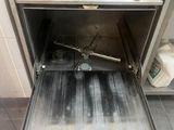 an open oven with the door open on a tiled floor