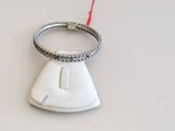 a ring on top of a computer mouse on a white surface
