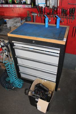 a workbench with tools on it in a garage