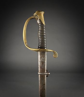 an old sword with a gold handle on a black background