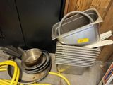 a pile of pots and pans sitting on the floor