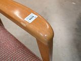 a wooden chair with a sticker on the back of it