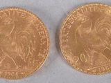 two pieces of gold coins, one of which is a rooster and the other of which is a rooster