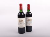 deux bouteilles de vin posées l'une à côté de l'autre sur une surface blanche