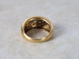 a close up of a gold ring with diamonds on it