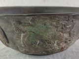 a close up of a metal bowl on a table