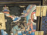 a black box with a painting on it sitting on the floor