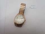a watch that is sitting on a white surface