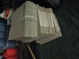 a pile of papers sitting on a table next to a chair