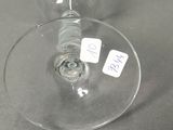 a wine glass with a tag on it sitting on a table