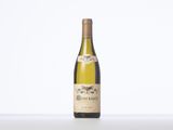 a bottle of white wine sitting on top of a table