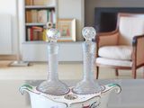 a white bowl with two candles on it in a living room