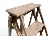 a small wooden step stool with two steps on it