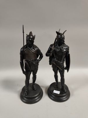 two bronze figurines of two men with spears and shields