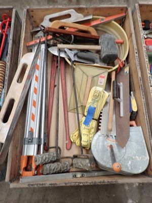 une boîte remplie d'outils posés sur le sol