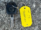 a yellow tag on a keychain with a yellow tag attached to it