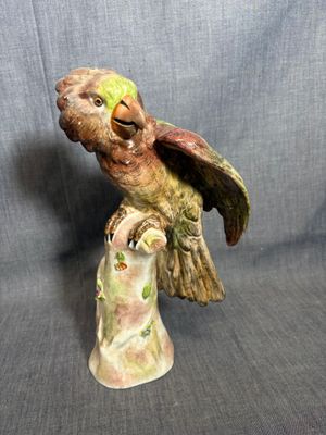 une figurine représentant un oiseau perché sur une souche d'arbre