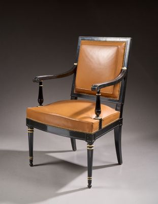 a black and brown chair with leather upholstered seat