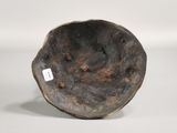 a close up of a metal bowl on a white surface