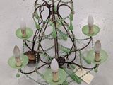 a green chandelier hanging from the ceiling in a room