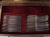 a wooden box with silverware in it on a table