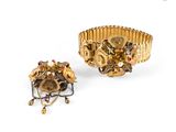 an image of a gold bracelet and a ring with red stones