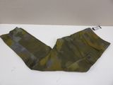 a pair of green pants sitting on top of a white table