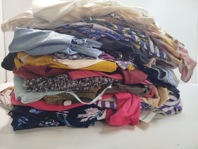 a pile of clothes sitting on top of a white table