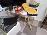 a television on a table with a lot of electronics on it
