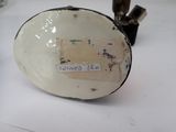 a white bowl with a tag on it sitting on a table