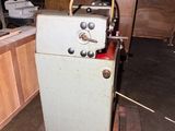 an old machine that is sitting in the middle of a room