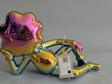 a small glass figurine of a woman on a bike