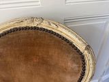 an antique chair with a brown velvet upholstered seat