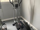an image of a gym room with a stationary bike and exercise equipment