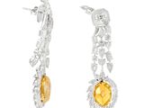 a pair of earrings with citrine and diamonds on a white background