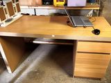 a desk with a laptop on top of it