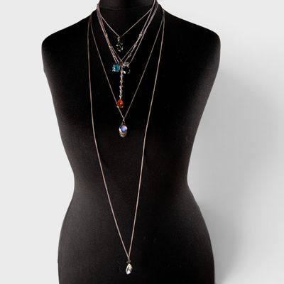 a mannequin with multiple necklaces on it