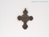 a cross on a white surface with a white background