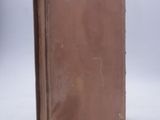 a brown book sitting on top of a white table