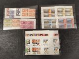 four different stamps from different countries are on display on a table